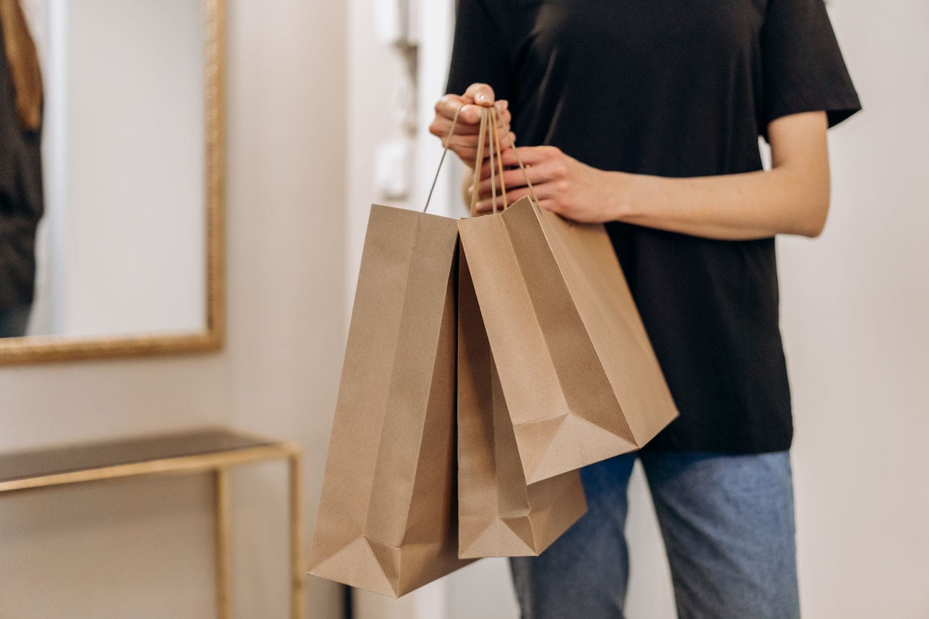 A shopper carrying paper bags, the booked shopping runs Maxi Cab Perth makes to Lakeside Joondalup and Karrinyup with boot space for every bag
